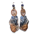 Loergann Studio artisan statement earrings with midnight blue and copper resin drops, hammered frames, and lapis beads.