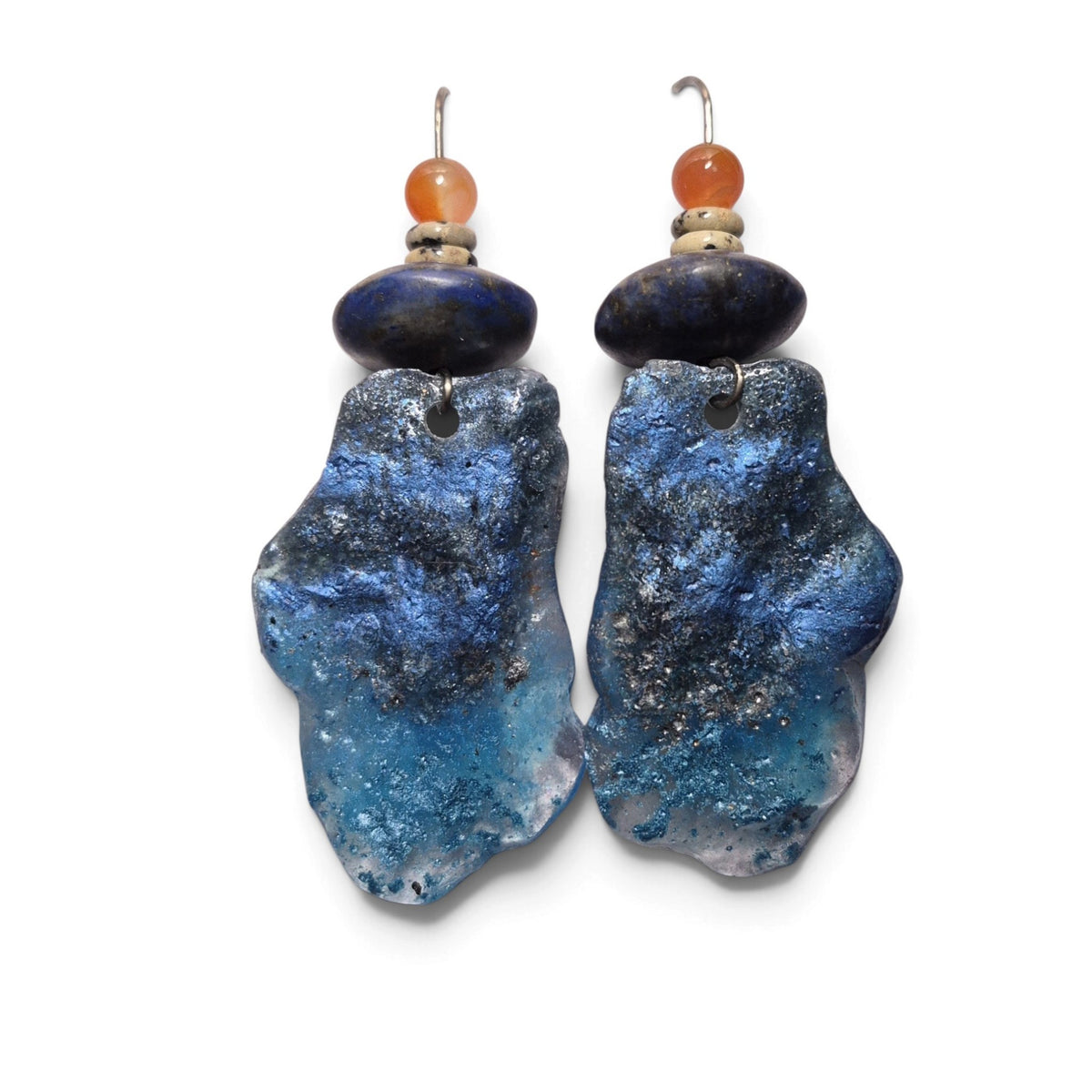 Loergann Studio artisan statement drop earrings with textured blue celestial drops, earthy beads, and metallic flecks.