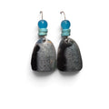 Loergann Studio artisan drop earrings with textured charcoal-grey shield pendants and vibrant turquoise bead accents.