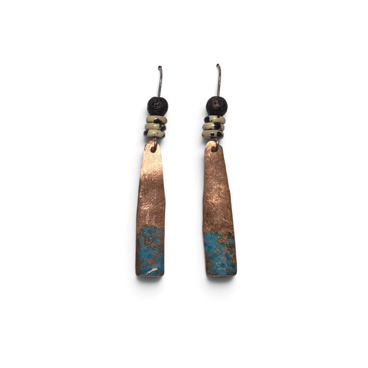 Loergann Studio artisan copper drop earrings with turquoise patina, black lava beads, and speckled ceramic accents.