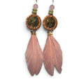 Loergann Studio artisan feather drop earrings with pink feathers, hammered copper discs, and moss-toned stone inlays.