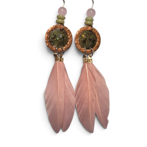 Loergann Studio artisan feather drop earrings with pink feathers, hammered copper discs, and moss-toned stone inlays.
