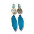 Loergann Studio artisan drop earrings with electric blue feathers, hammered gold discs, and pale green jade beads.
