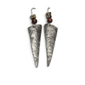 Loergann Studio handcrafted triangular drop earrings with hammered metal finish, brown beads, and dalmatian stone accents.