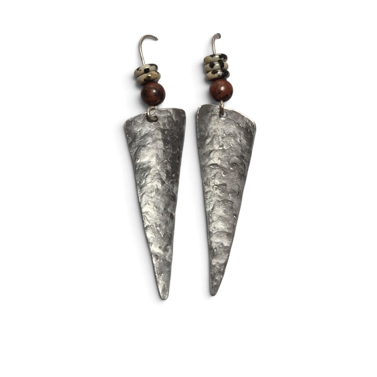 Loergann Studio handcrafted triangular drop earrings with hammered metal finish, brown beads, and dalmatian stone accents.