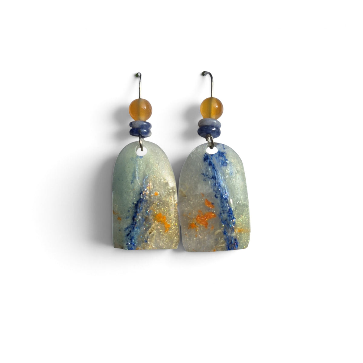 Loergann Studio artisan drop earrings featuring sage green resin pendants with blue and orange flecks and amber beads.
